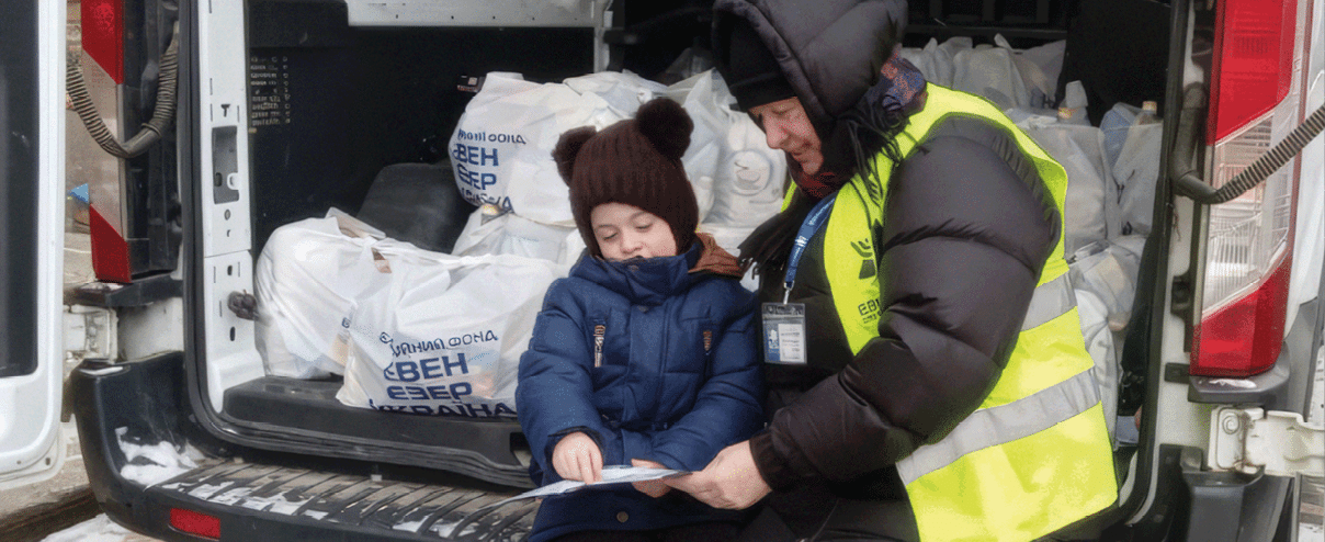 A man and a child are standing in front of a white van. Description generated by AI